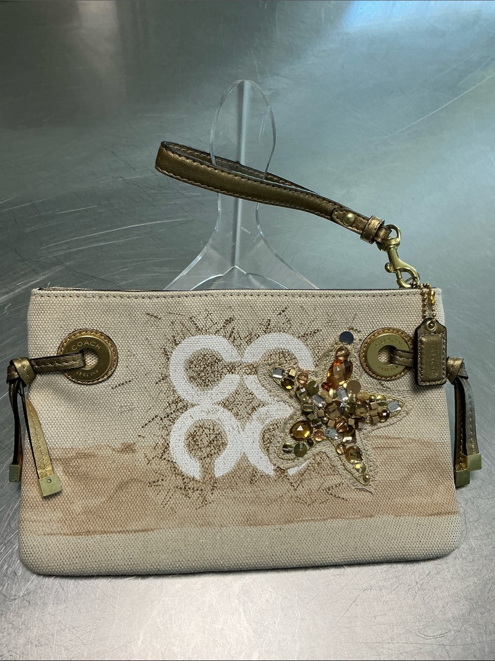 Coach Audrey, beaded starfish on sandy shore wristlet.